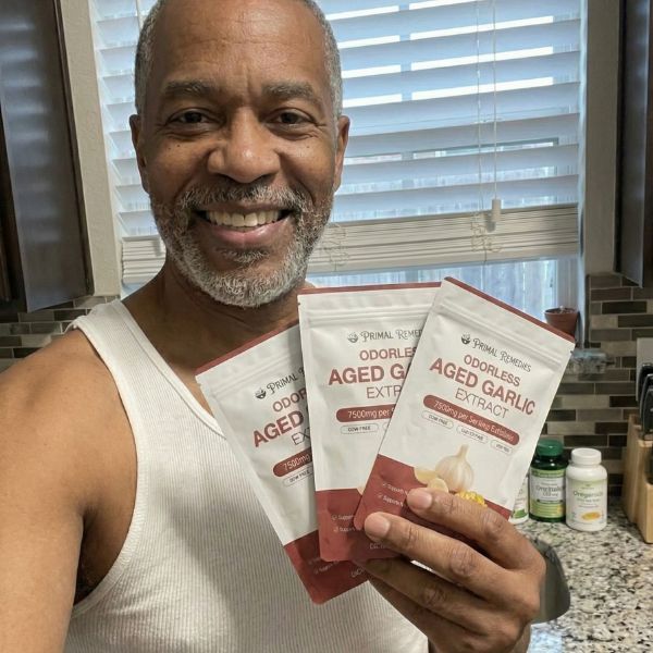 Primal Remedies customer holding Aged Garlic Extract pouches